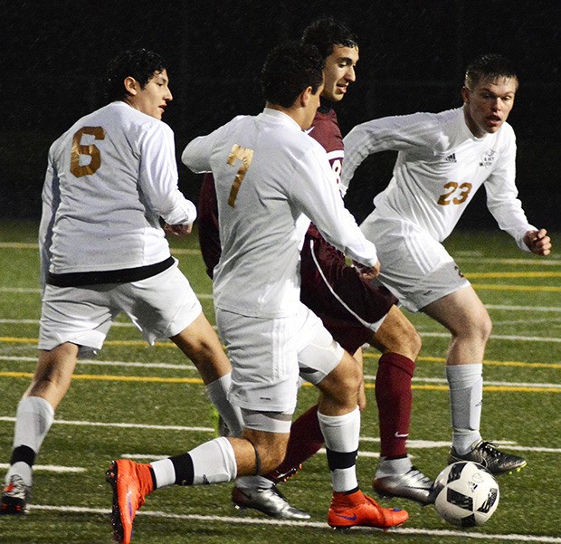 The Arlington boys soccer team's defense works to contain an Eastlake player.