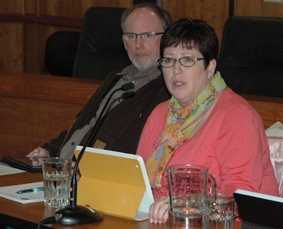Arlington City Council member Chris Raezer listens as fellow Council member Debora Nelson inquires about the development impacts of the Arlington/Marysville manufacturing/industrial center on March 10.