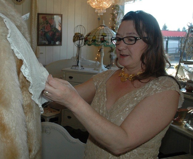 Linda Gudde puts the finishing touches on a vintage dress.