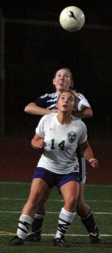 Arlington defender Maddy Grogan fights with Edmonds forward Cameron McCarthy for position of a header.