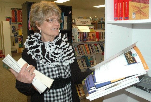 Pacific Learning Solutions owner Nola Smith sorts through the store's stock during its closeout sales.