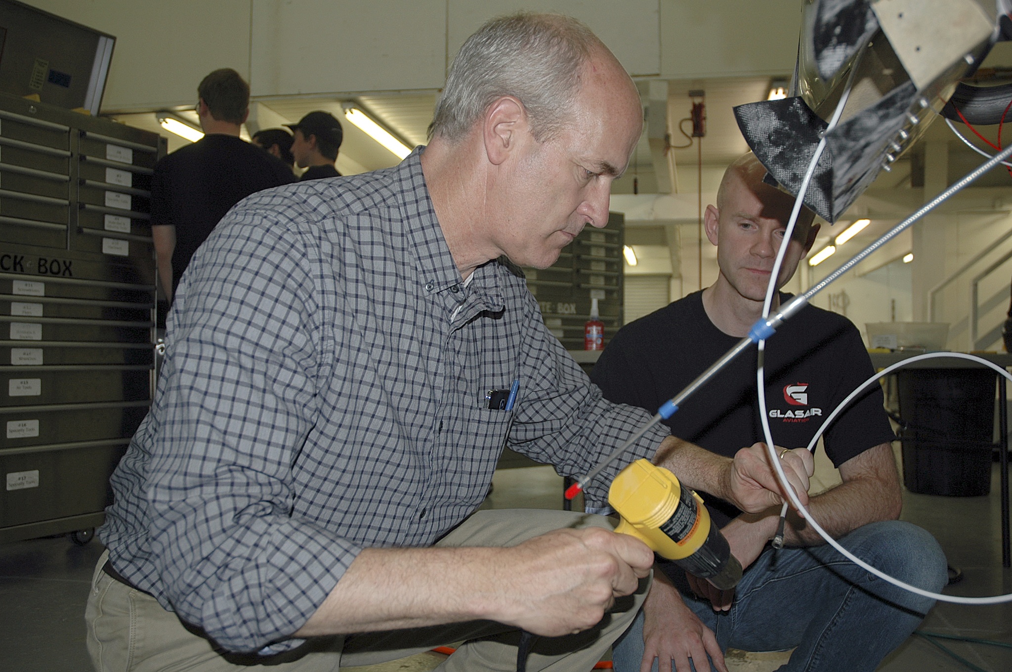 Kirk Boxleitner/Staff PhotoU.S. Rep. Rick Larsen tries his hand at working on a Glasair Sportsman aircraft engine