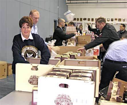 Navy League Everett Chapter President Kathy Gambill helps 40 volunteers put together Thanksgiving baskets for area sailors in 2008.