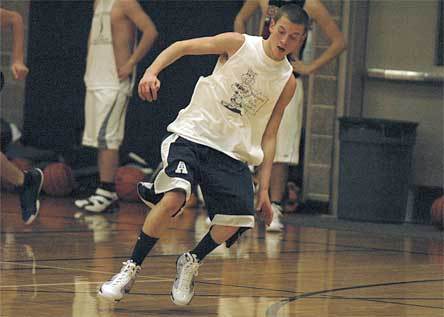 Junior point guard Zach Cooper runs lines at the start of practice.
