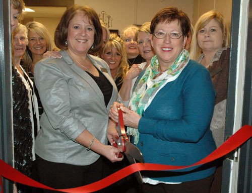Hallmark Homes NW owner and designated broker Wendy Smith cuts the ribbon to her business with Arlington City Council member Debora Nelson