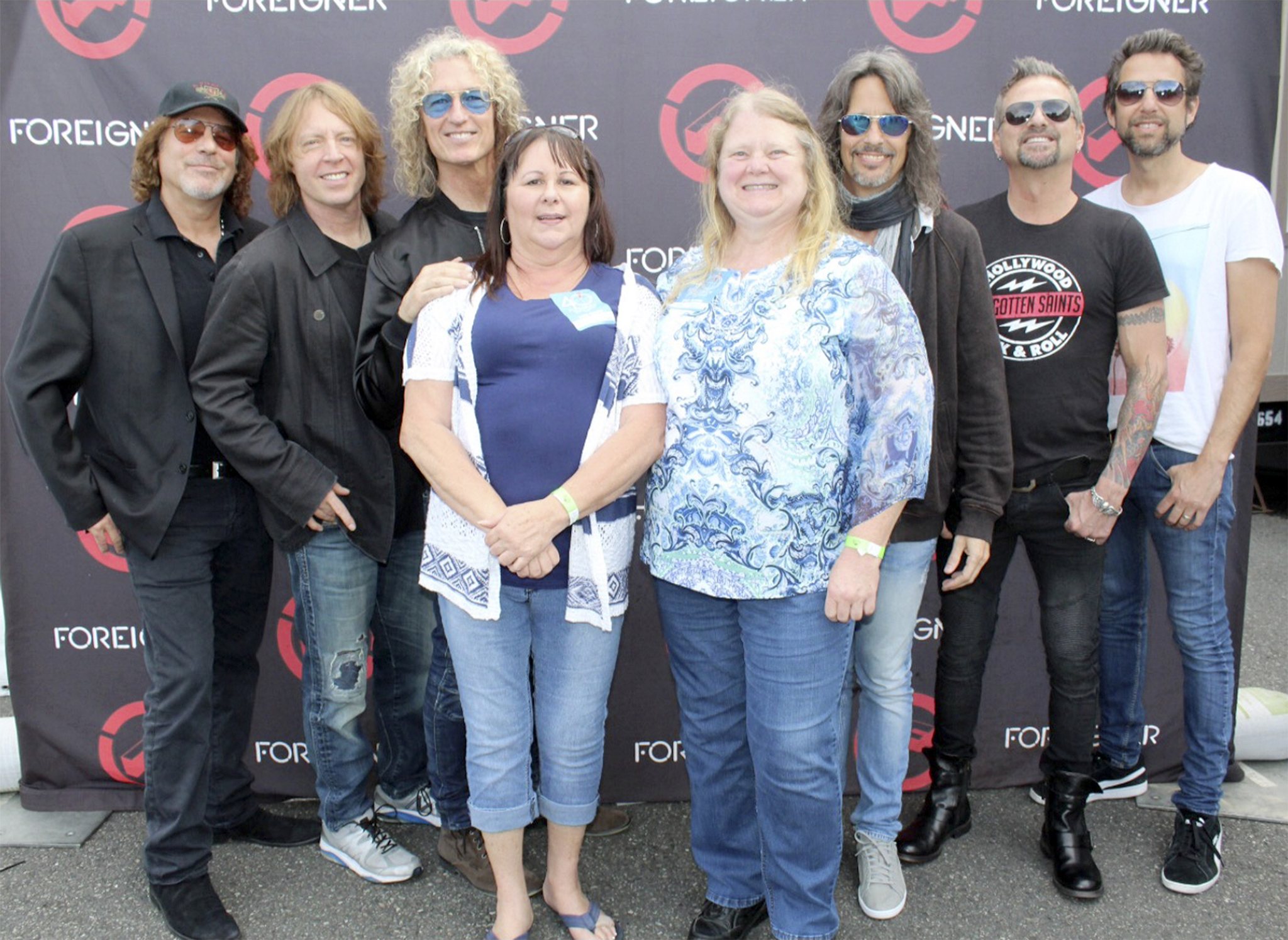Arlene Klemme of Marysville and Barbara Roy of Arlington pose with the band Foreigner at Tulalip Friday night after winning the grand-prize drawing for meet-and-greet tickets