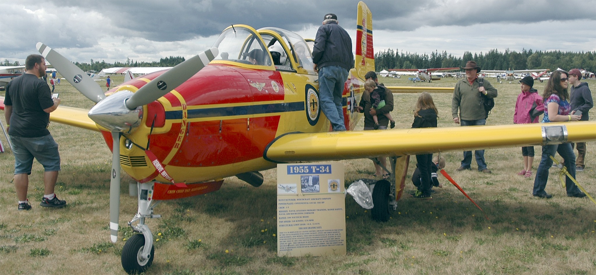 Kirk Boxleitner/Staff PhotoJon Haynes invites kids to sit in the cockpit of his 1955 T-34 Beechcraft Navy pilot trainer and nuclear test site range flier.