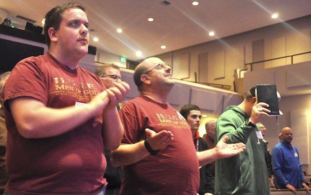 H.U.G.E. Men of God participants son Josh and father Dave Lord get into the spirit at the Arlington Assembly of God Jan. 26.