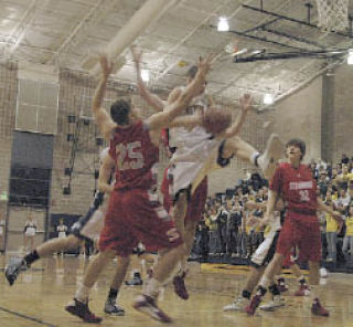 Arlington senior A.J. Richardson fights for an early rebound against a Stanwood team that used height to its advantage.