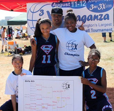 Members of the 2012 sixth-grade girls team “Game Time Swag” pose with their winning bracket at the annual 3-on-3 X-travaganza at the Arlington Municipal Airport.