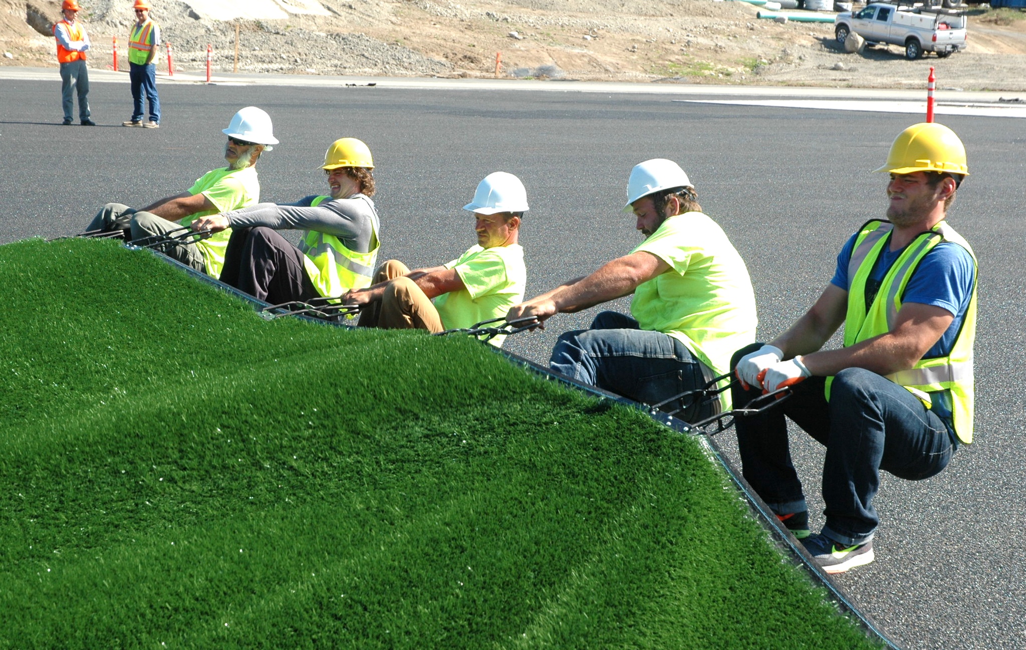 Kirk Boxleitner/Staff PhotoConstruction crews put down segments of artificial turf for Lakewood High School’s new field.