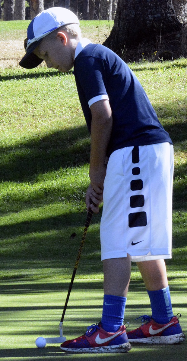 Kids take a swing at golf during summer