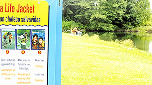 A sign at Twin Lakes near Smokey Point tells visitors to use a life jacket if they can't swim