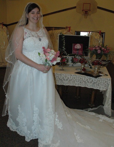 Shopper Kari O'Sullivan models one of the gowns at the Bridal Dress Swap Meet on Feb. 22.