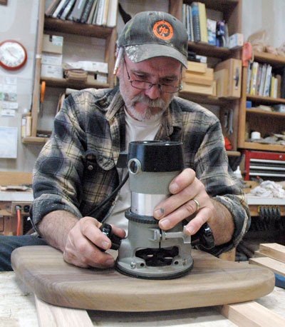 Arlington’s Michael Wendland crafts an organic-looking lamp out of carefully chosen wood at his Catpaw Custom Furniture studio.
