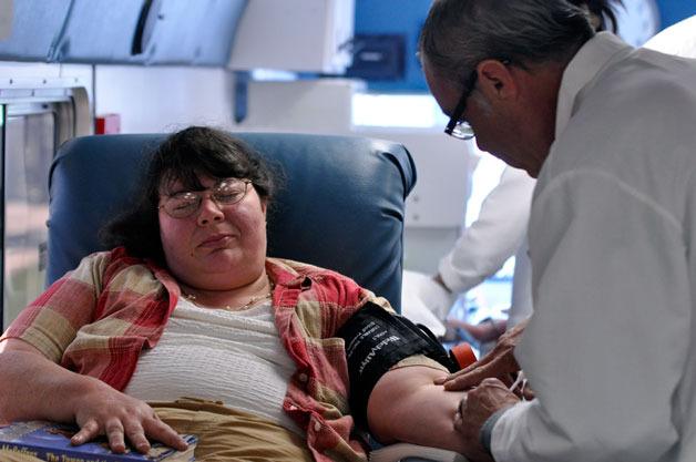 Arlington Food Bank Food Drive Coordinator Dori Spear donates blood during the third annual Carbajal Family blood drive on May 19.