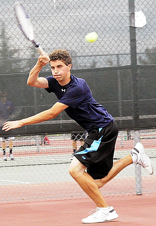 Arlington senior captain Connor Ghirardo plays a singles match during Arlington's contest against Lake Stevens Sept. 9.