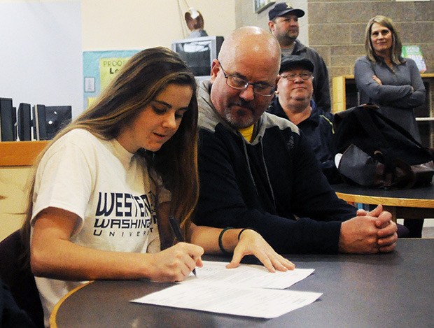 Olivia Larson of Arlington signs her letter of intent to play soccer for Western Washington University Feb. 3.