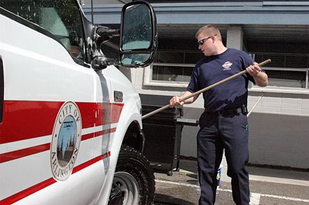 Arlington Fire Department paramedic Justin Honsowetz washes a vehicle during a recent shift at the downtown station.