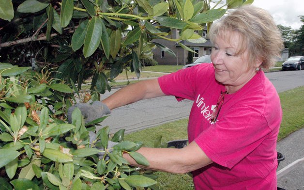 Windermere’s Patty Weeda proudly sports the same community service day T-shirt at Centennial Park on June 21 that she wore more than two decades ago.