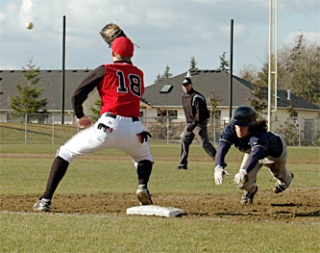 Arlington outfielder Tony Geist dives back to first in the fourth inning after earning the base on a Snohomish error. He went on to steal second base.