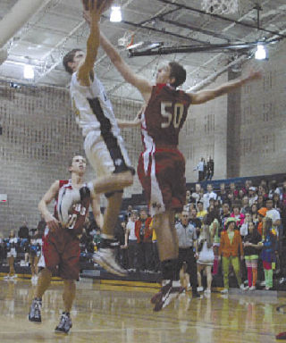 Arlington guard Cole Carpenter drives the ball against Tomahawk post Spencer Elwell. Carpenter ended the game with 18 points.