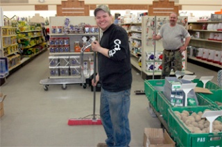 James Osterud and Dave Stefanich sweep up the floor at the new home of Co-op Supply about noon Sunday after starting the move from the old building about 7:30 a.m.