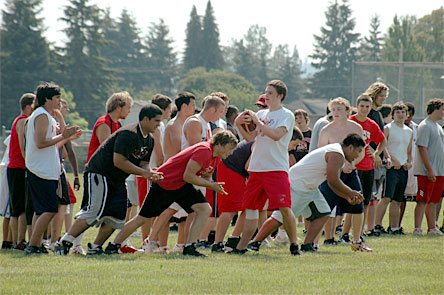 Senior quarterback Zach Hanson slaps the ball