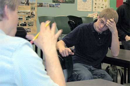 Arlington Hi-Q team member J.D. Boston ponders a question from adviser Ben Mendro on Feb. 24.