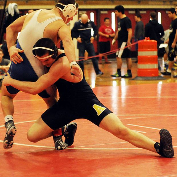 An Arlington wrestler goes for the take down.