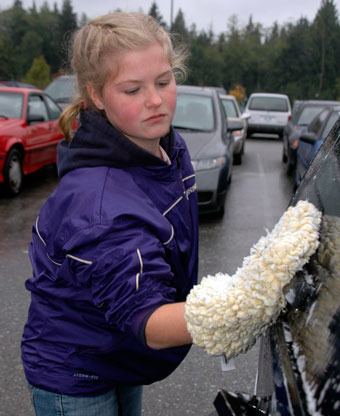 Arlington High School senior Evie Aylesworth was one of close to 150 AHS Band students who washed cars on Oct. 1 to help raise funds for their program.