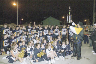 While coach Jim Welton congratulates his team