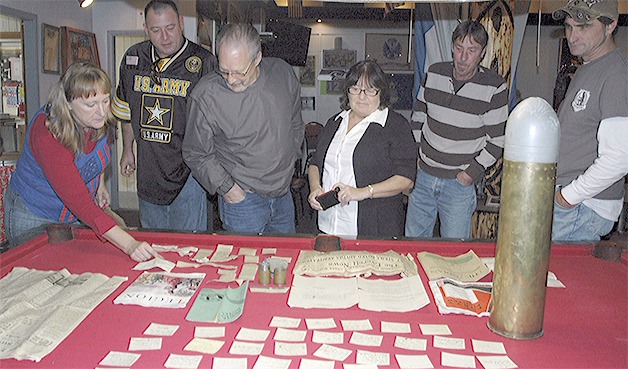 Historical items on the table were found inside the artillery shell that has been part of a memorial at the lounge for years.