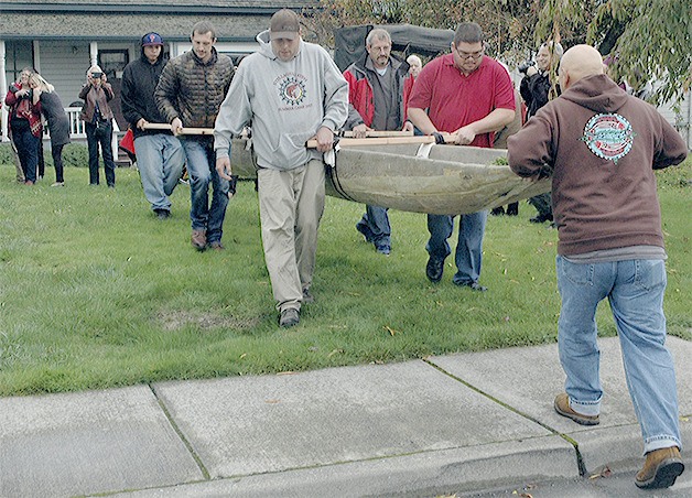Members of the Stillaguamish Tribe carry a canoe that was stolen years ago.