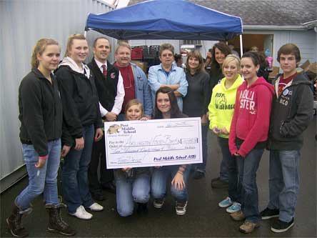 Students from Cody Decker’s sixth-grade class were joined by school district staff to present a check for $2