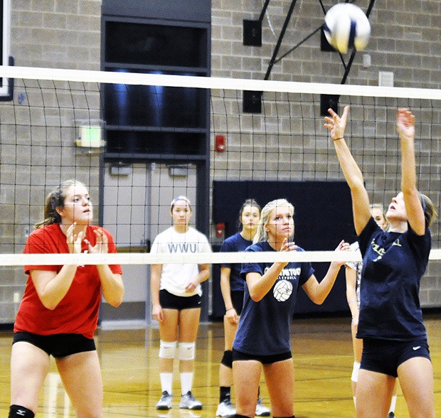 Arlington volleyball players practice setting before fall season goes underway.