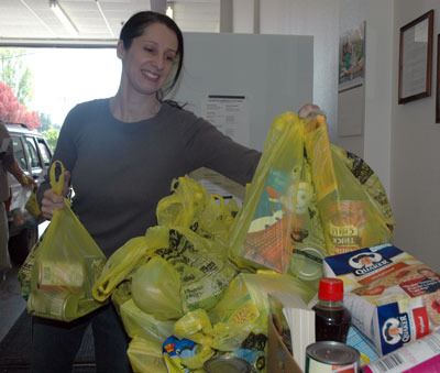 Volunteer Kelly Marlo weighs bags of food during the May 12 National Association of Letter Carriers Food Drive at the Arlington Community Food Bank.
