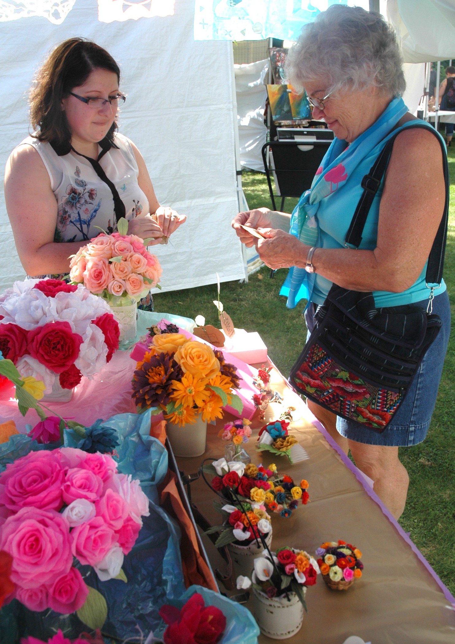 Kirk Boxleitner/Staff PhotoAdriana Armendariz sells hand-sculpted jewelry to Jeannie Lish at the Arlington Arts Council’s ninth annual “Art in the Park” event Sept. 10.
