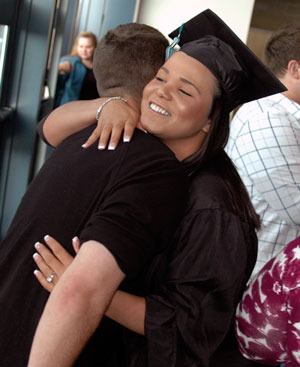 Weston High School senior Daunisha Neitzel gets a hug before the school's graduation ceremony on Wednesday