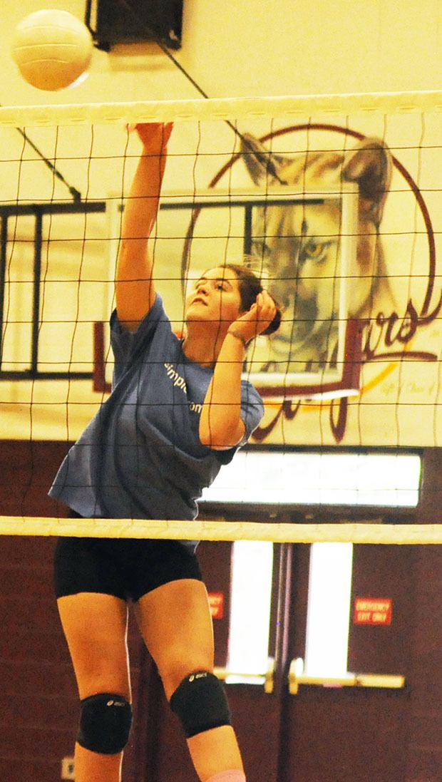 A Cougar player spikes the ball at a recent practice.
