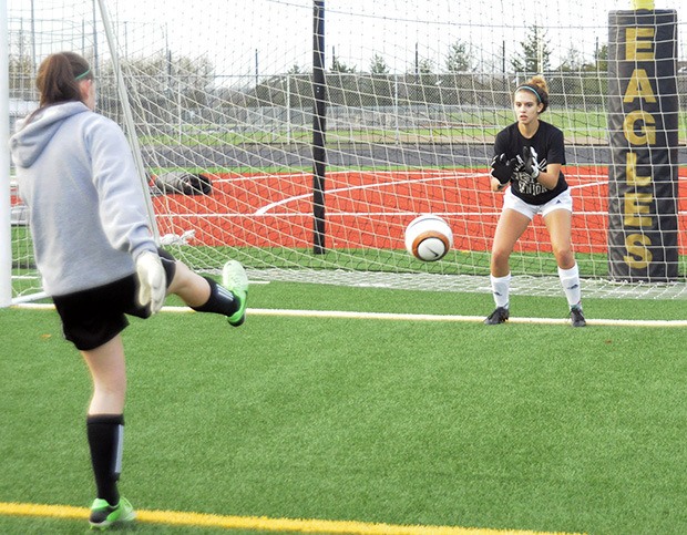 Arlington senior goalkeeper Kat Sanchez hones her saving skills during a soccer practice.