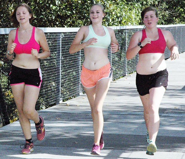 Members of the girls cross country team job to get into shape.