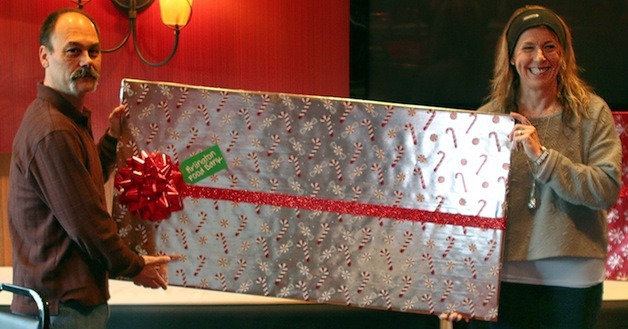 Stillaguamish Tribal Chair Shawn Yanity presents a gift-wrapped oversized check for $100