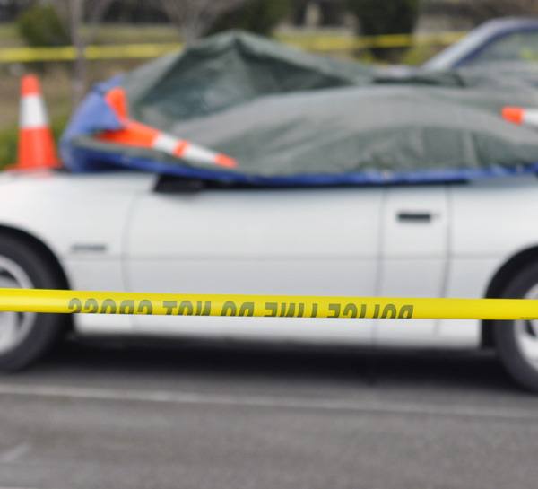 A police line was drawn around a white two-door vehicle in the Arlington Haggen parking lot after a body was found inside on Thursday