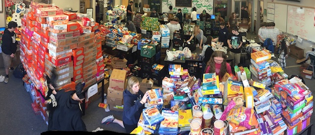 Arlington High School DECA students sort through the food donations they collected Dec. 12-13.
