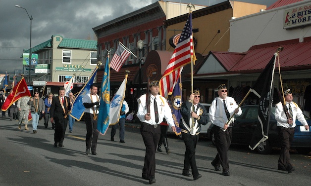 Members of Arlington American Legion Post 76 march sharp down Olympic Avenue for the city's Veterans Day parade.