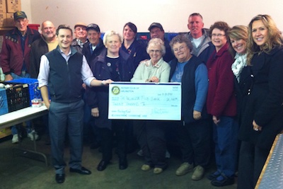 Rotary Club of Arlington President John Peeters presents a $20