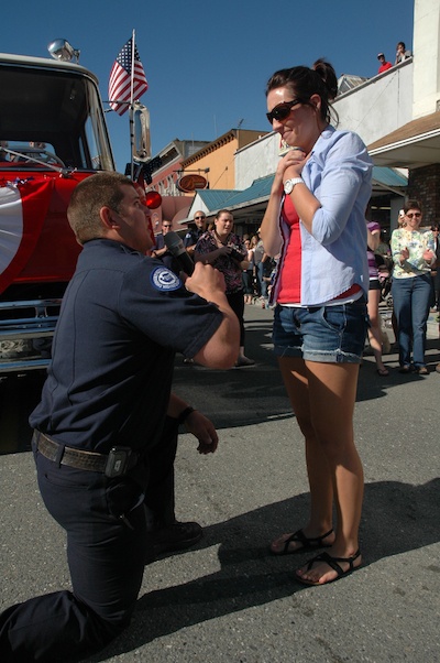 Arlington firefighter Erik Gustafson proposes to girlfriend Jacklyn King during Arlington Fourth of July Grand Parade.