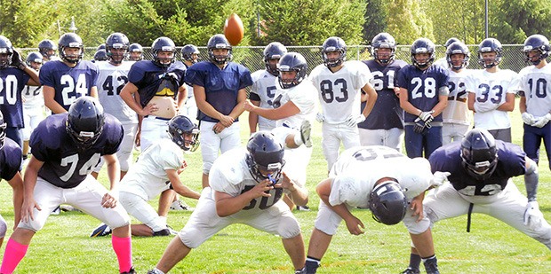 Arlington high school football kicking team practices during a drill.