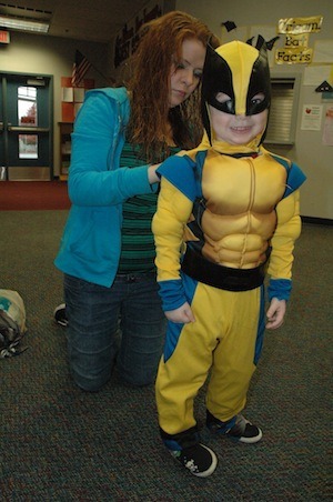 Karen Whitehead helps her son Bryson don his Wolverine costume at the Oct. 22 'Give a Costume